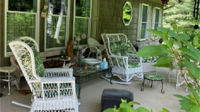 Hidden Ridge covered porch with wicker chairs